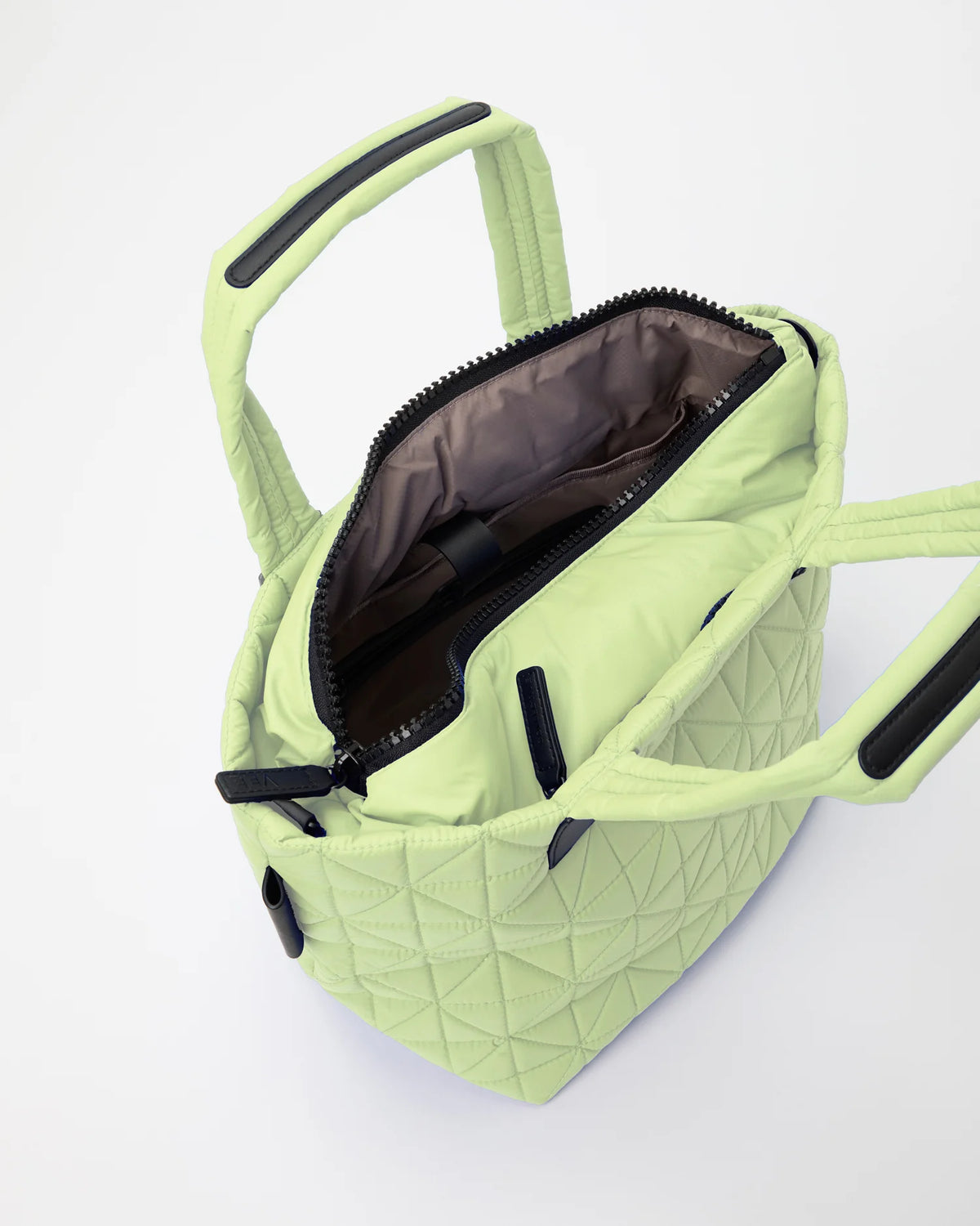 Open Vee Collective Vee Tote Small in Limelight, showing the quilted exterior, top zipper, and interior compartments of the tote bag.