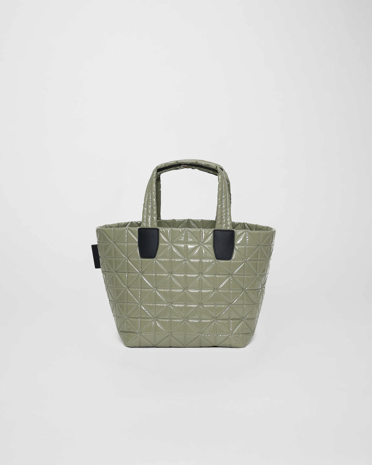 A small sage green tote bag featuring a quilted triangle design with geometric stitching. The bag has two sturdy handles and a sleek, modern appearance, making it suitable for various activities and settings.