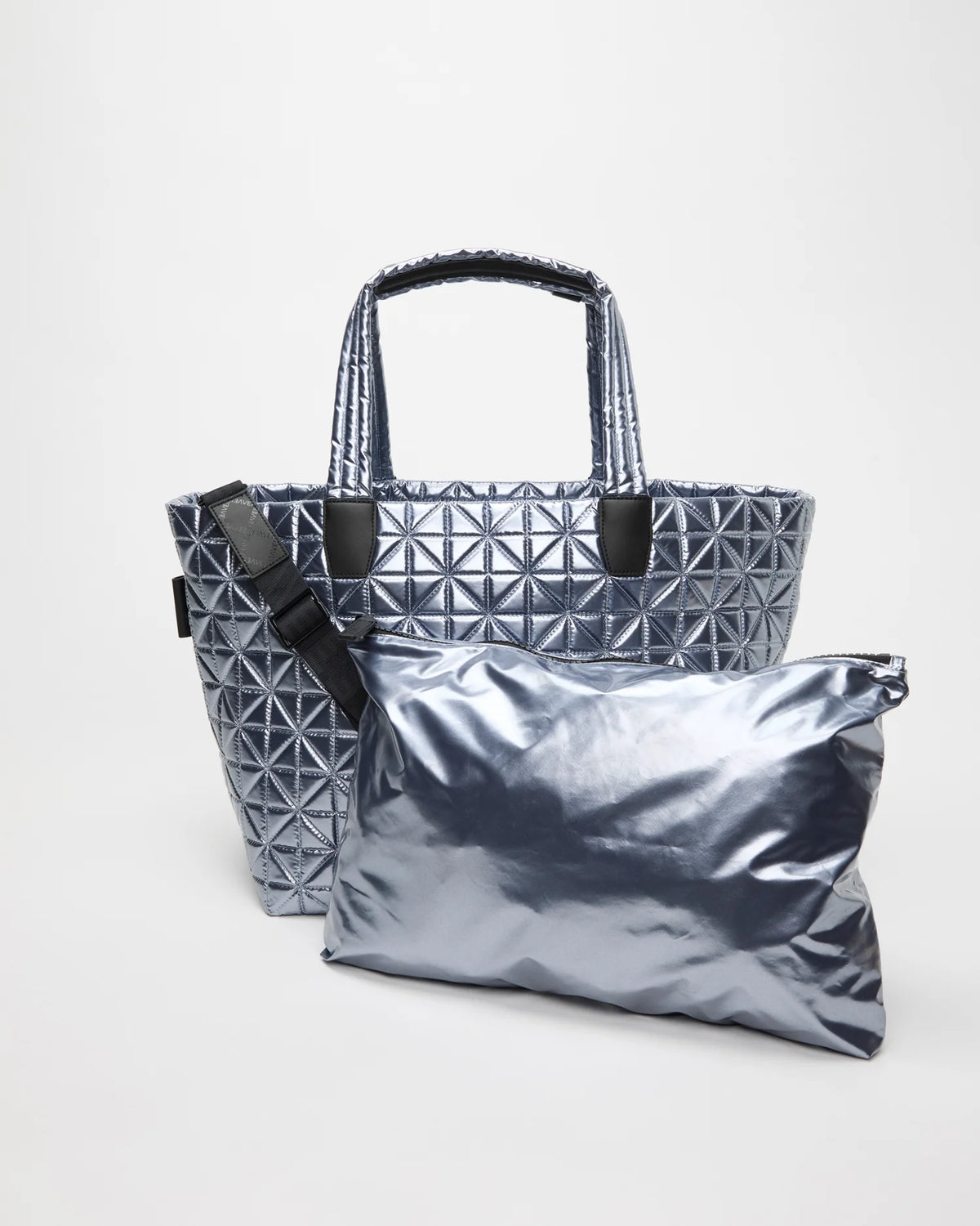 Front view of the Vee Weekender tote bag in Icy Silver, shown with its matching pouch and detachable strap.