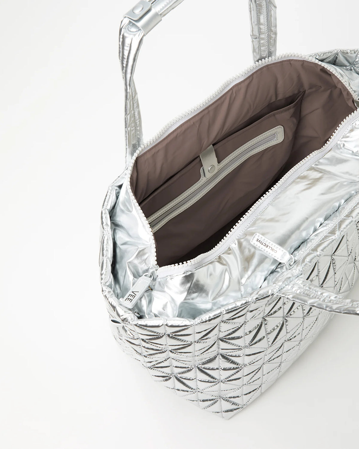 Silver quilted handbag with brown interior lining on a white background